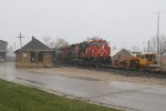 As a brief snow squall passes, X342 rolls past the old depot